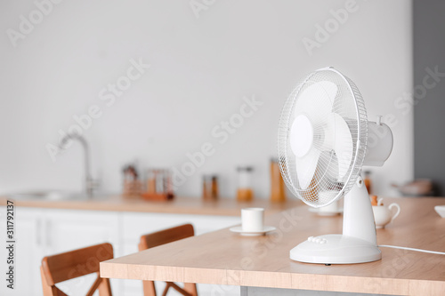 Obraz na plátně Electric fan on table in kitchen