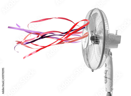 Electric fan with fluttering ribbons on white background