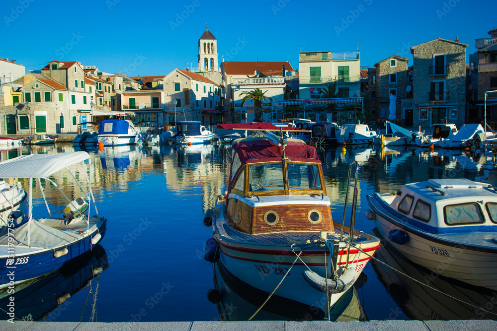 Vodice, Croatia / 17th May 2019: Boats in marina Vodice and old stone houses in city centre