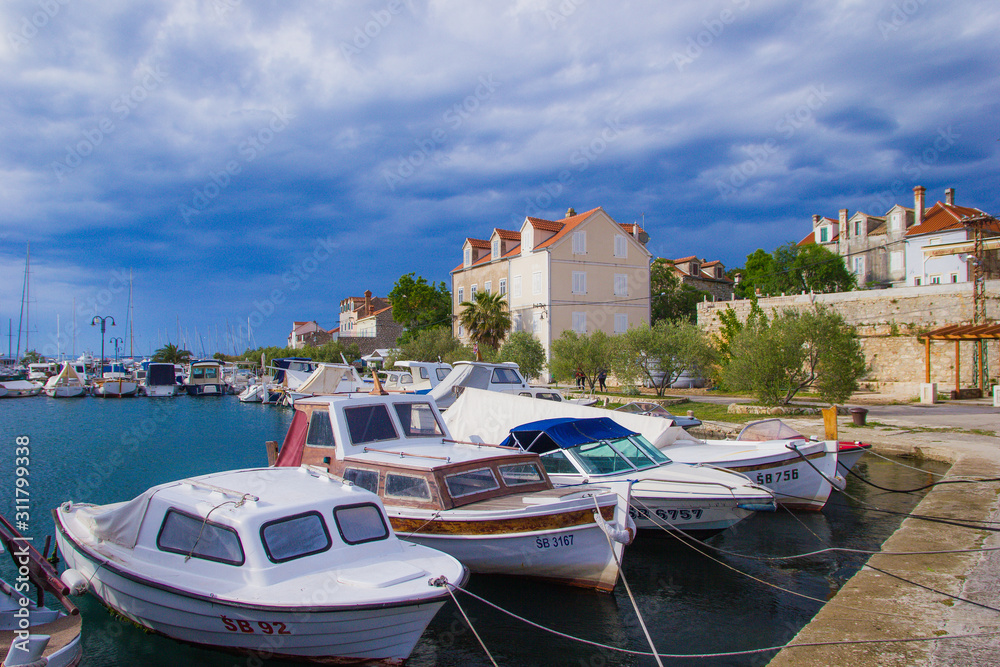 Zlarin, Croatia / 18th May 2019: Boats and old stone houses in Zlarin island near Sibenik