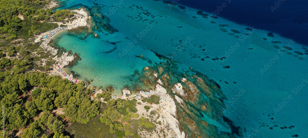 Aerial drone ultra wide photo of beautiful turquoise bay and beach of Kavourotripes with rocky seascape in Sithonia Peninsula, Halkidiki, Greece