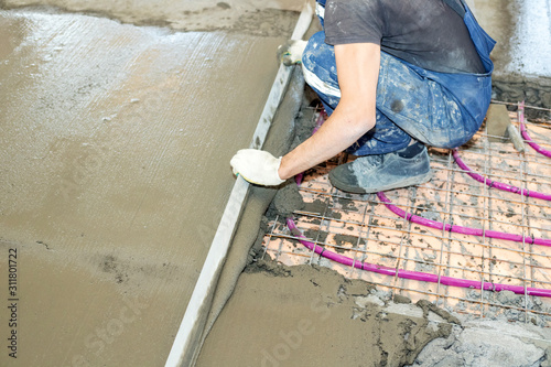 Installation of Underfloor heating, heated with antifreeze. Underfloor heating with heat transfer fluid. Cement screed with metal reinforcement
