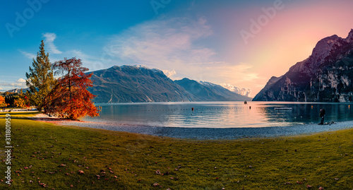 Fototapeta Naklejka Na Ścianę i Meble -  Beautiful and colorful autumn in Riva del Garda, Garda lake surrounded by mountains, Trentino Alto Adige region, Lago di garda, italy
