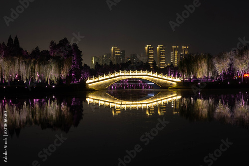 Night view of Chinese bridge with light decoration at East Lake Wuhan, Hubei, China