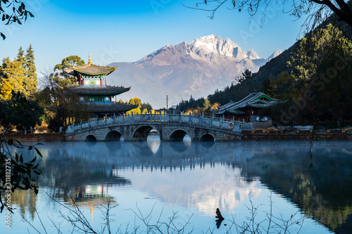 Beautiful of Black Dragon Pool with Jade Dragon Snow Mountain background, landmark and popular spot for tourists attractions near Lijiang Old Town. Lijiang, Yunnan, China