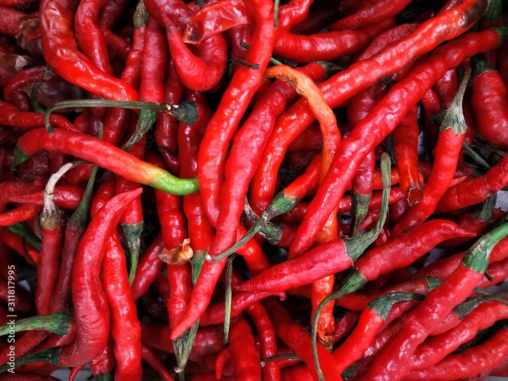 Pile of red chili peppers background texture pattern at market