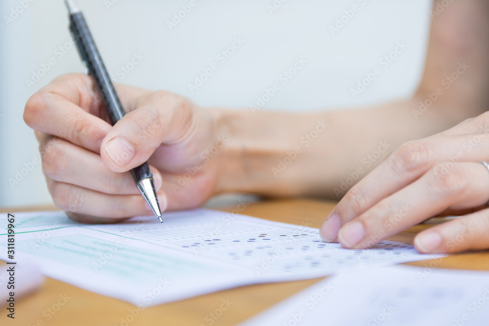 high school,university student study.hands holding pencil writing paper answer sheet.sitting lecture chair taking final exam attending in examination classroom.concept scholarship for education abroad high school,university student study.hands holding pencil writing paper answer sheet.sitting lecture chair taking final exam attending in examination classroom.concept scholarship for education abroad