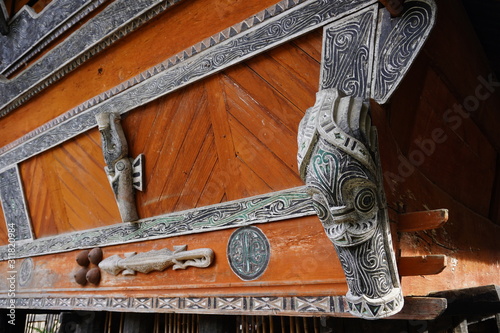Batak carving on the wall of the village in the area of the Toba lake. Samosir Island, Indonesia photo