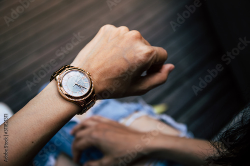 looking at luxury watch on hand check the time.concept for managing time organization working,punctuality,appointment.fashionable wearing stylish
