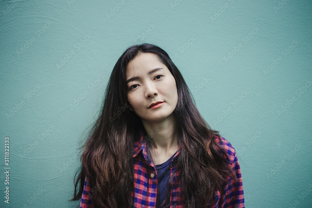 Obraz premium portrait happy cheerful young brunette asian woman with perfect smilling,clean skin.beautiful girl posing show white teeth smile relaxing.fashion people freedom life style concept