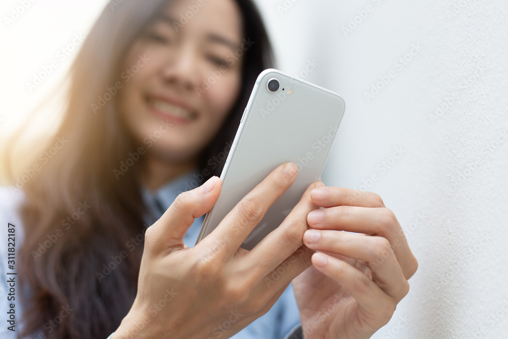 using cell phone.hand holding texting message on screen mobile chatting friend ,search internet information sitting on sofa in office.technology device contact communication connecting people concept using cell phone.hand holding texting message on screen mobile chatting friend ,search internet information sitting on sofa in office.technology device contact communication connecting people concept