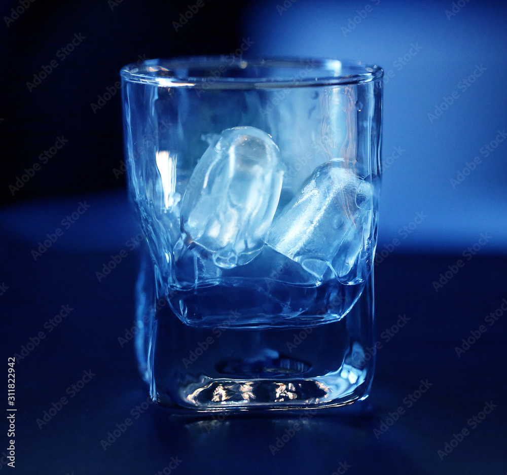 Photo macro blue ice in a transparent glass Photo macro blue ice in a transparent glass