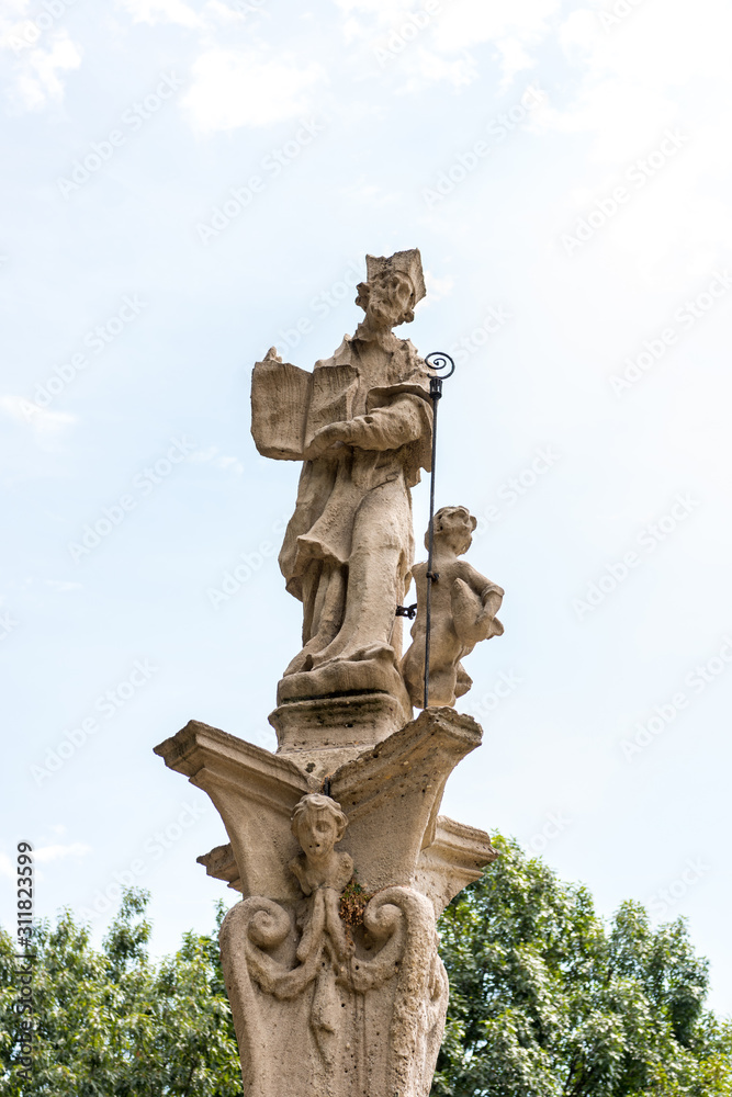 Religious statue outside of the Basilica of San Lorenzo, Milan,  originally built in Roman times and subsequently rebuilt several times, close to the mediaeval Ticino gate.
