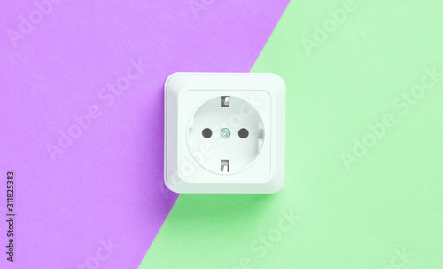 Power socket on colored paper background, minimalism