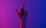 Woman insulting hand gesture with neon light