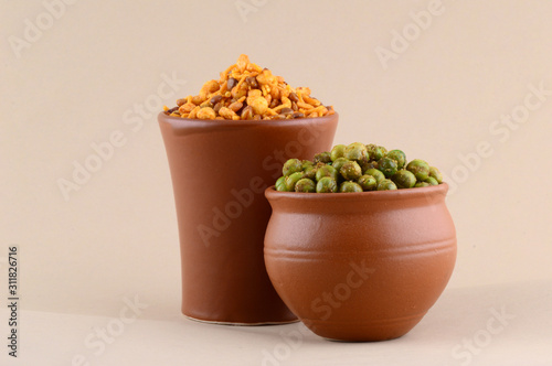 Indian snack: Mixture and Spiced fried green peas {chatpata matar} in clay pots. photo