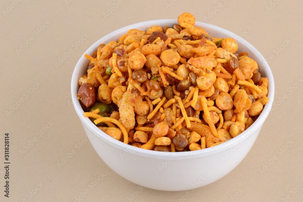 Indian Snacks : Mixture (roasted nuts with salt pepper masala, pulses, channa masala dal green peas) in blue bowl in Indian Snacks : Mixture (roasted nuts with salt pepper masala, pulses, channa masala dal green peas) in blue bowl in