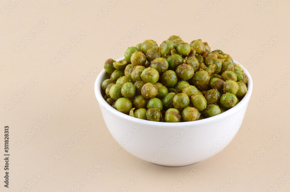 Spiced fried green peas {chatpata matar} Indian snack. Dried salted green peas Stock Photo