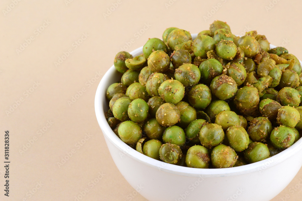 Spiced fried green peas {chatpata matar} Indian snack. Dried salted green peas Stock Photo
