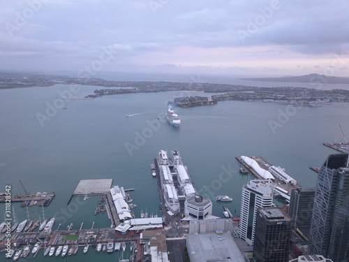 Viaduct Harbour, Auckland / New Zealand - December 25, 2019: The iconic Skytower landmark of Auckland City and its surrounding buildings © Julius