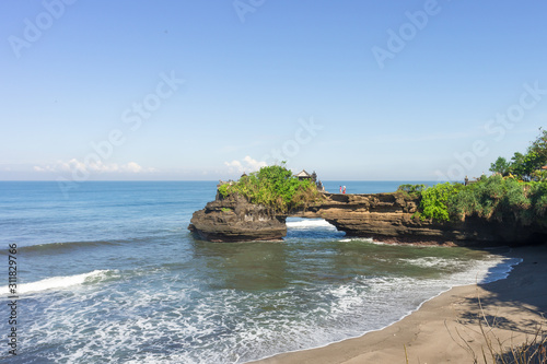 Pura Batu Balong Temple on Segara Batu Balong Beach, Ubud, Bali, Indonesia or Temple with a hole in the stone. photo