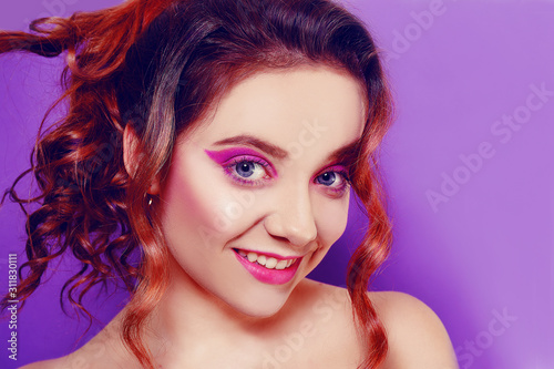 Beautiful young girl with purple make-up, on a purple background. Ideal makeup, eyebrows.