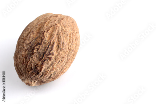 Nutmeg isolated on white background. Close up. photo