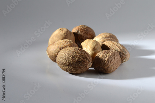 Close up of Nutmeg on a gray background photo