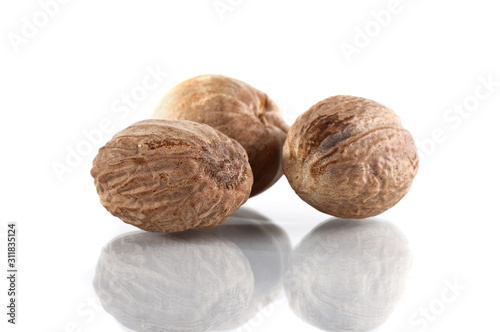 Nutmeg isolated on white background. Close up. photo