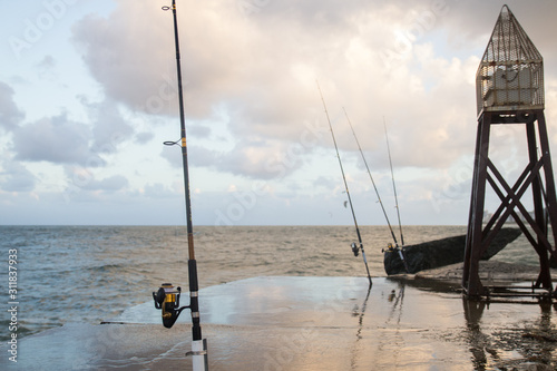 fishing rod and boat in sea