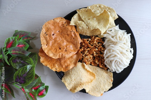 Mixed Papad or Papadam Platter served on a wooden table. Sabudana chakli, Rice, Sabudana potato Papad. photo