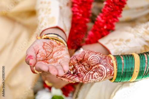 Traditional indian wedding ceremony, groom holding hand in bride hand photo