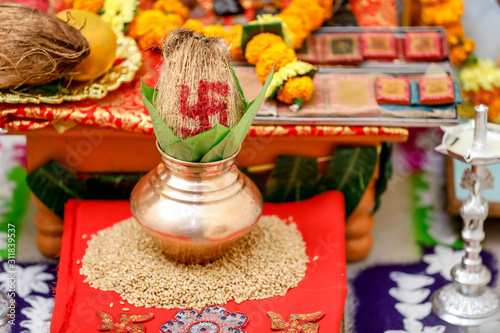 Indian wedding ceremony : decorative coper kalash with green leaf and coconut 