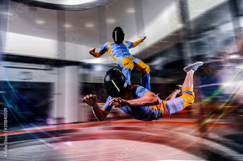 Jump. Free fall in open air. Sky jump like a hobby of extreme people. Flying men make professional jump. Skydiver in blue and yellowsuit. Extreme as a hobby.