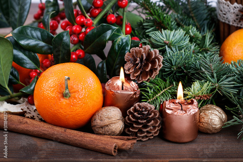 Christmas decoration with fir, oranges and cones.