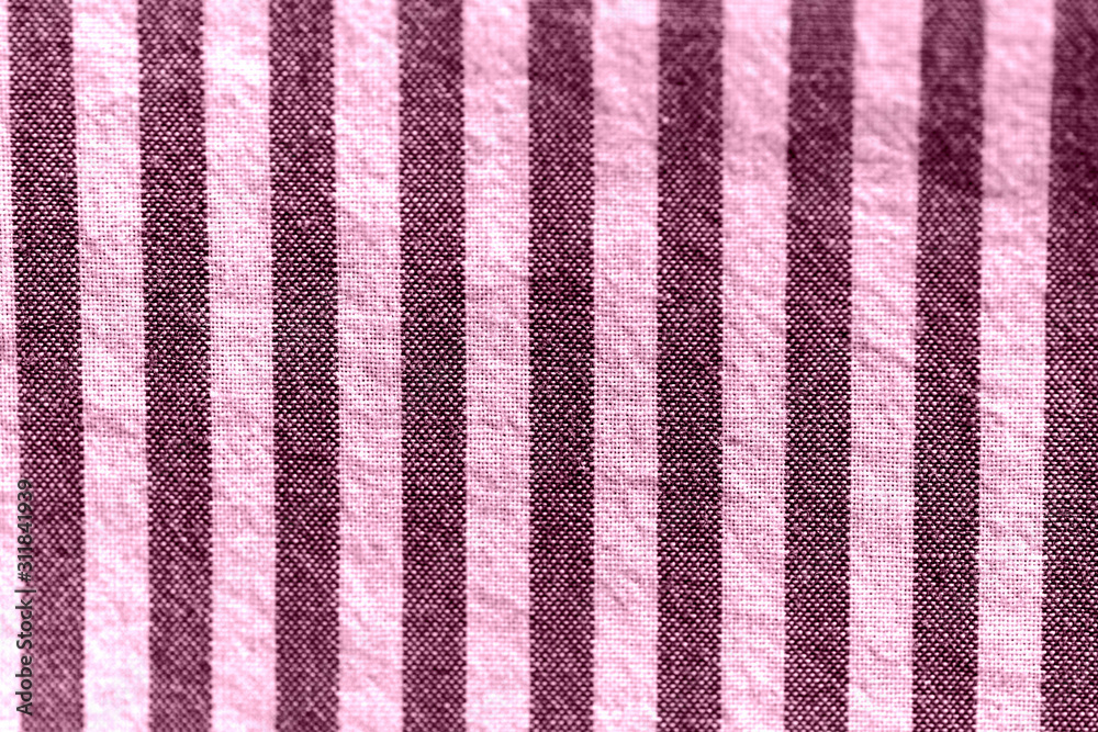 Striped textile background close-up. Pink color toned