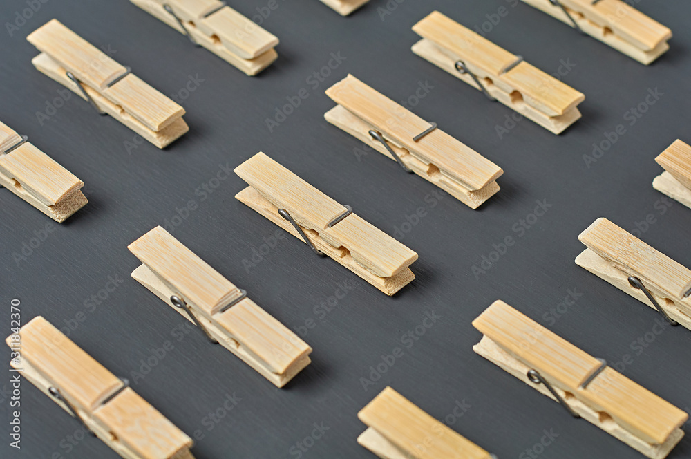 Rows of many wooden clothespins lies on dark concrete desk in bathroom. Close-up Rows of many wooden clothespins lies on dark concrete desk in bathroom. Close-up