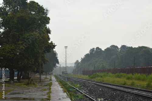 Landscape image of a railway station in rainy season photo