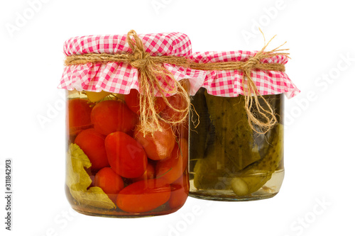 Canned vegetables. Red tomatoes and Green cucumbers in brine in the bank, isolated