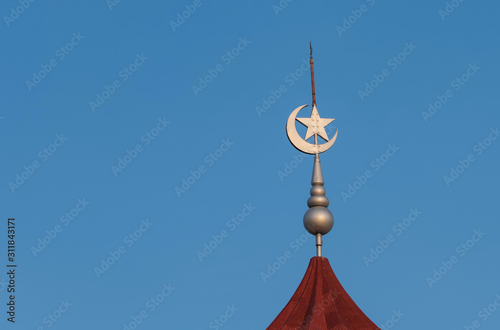 The Star and crescent moon on the top of the mosque is a symbol of Islam. The Star and crescent moon on the top of the mosque is a symbol of Islam.