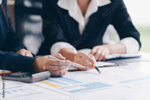 Businesswoman hand pen pointing on business document at meeting discussion and analysis data the charts and graphs showing the results at meeting.Business financial and accounting concept.