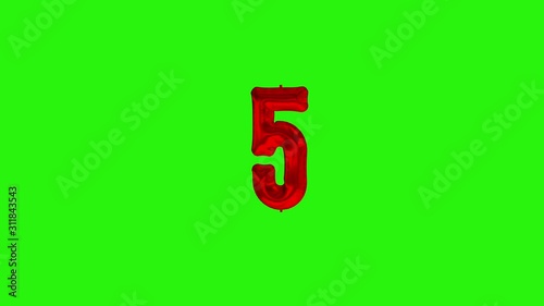 Number 5 five fivth year celebration red foil balloon floating on green photo