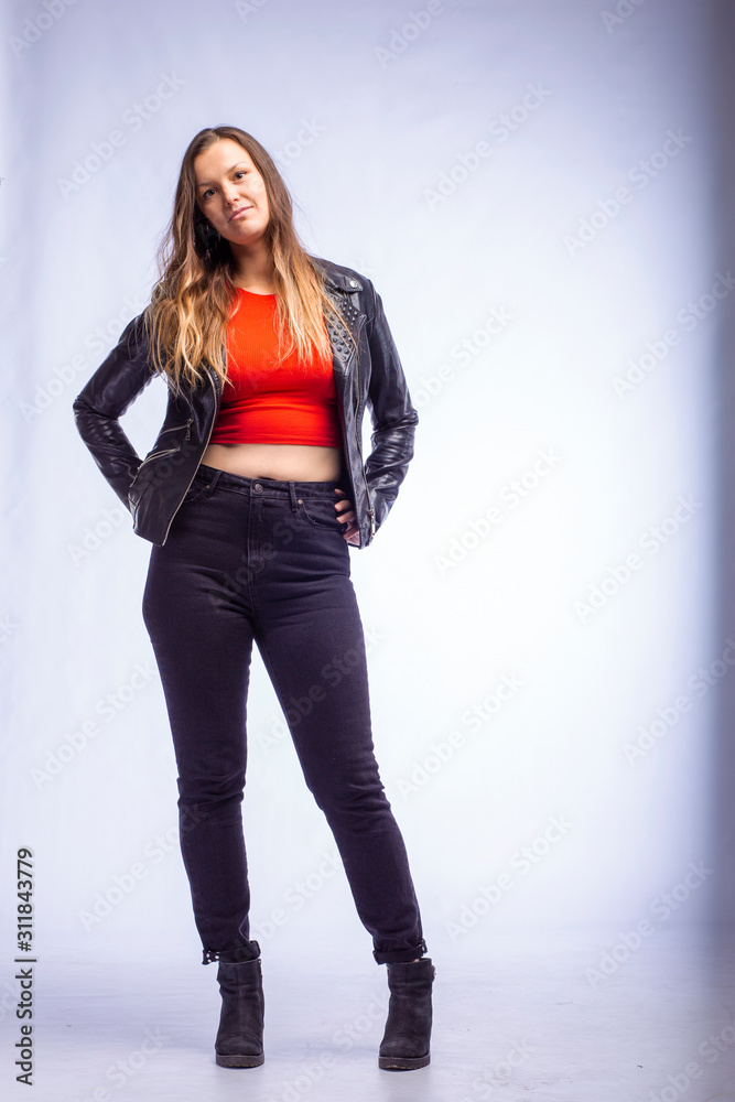 studio portrait of a young woman in a leather jacket on a white background studio portrait of a young woman in a leather jacket on a white background