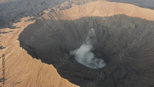 Aerial drone view of volcanic gas and steam venting from the active crater of a volcano (Mount Bromo, Java, Indonesia) photo