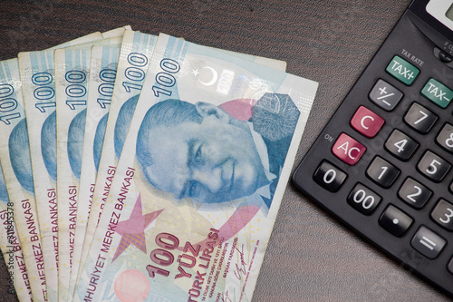 turkish lira banknotes on the table, minimum wage on the calculator screen photo