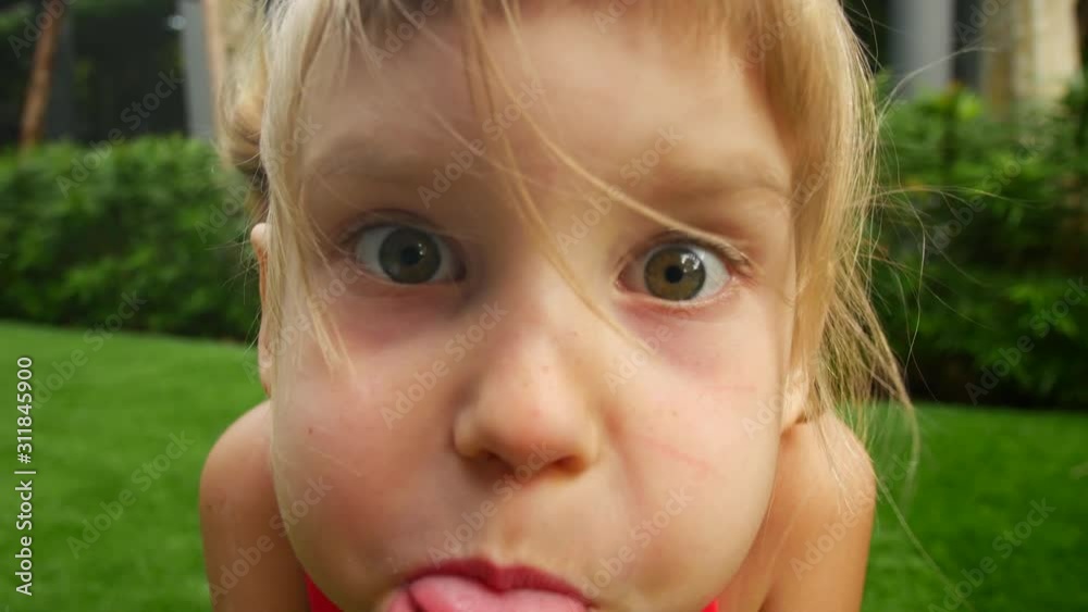 Portrait of a child. Girl makes faces and makes grimaces Portrait of a child. Girl makes faces and makes grimaces