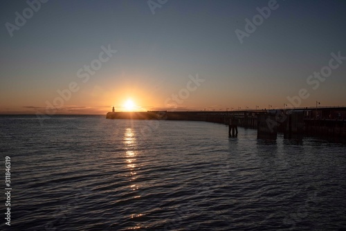 Fototapeta Naklejka Na Ścianę i Meble -  Folkestone's Harbour Arm at sunrise.