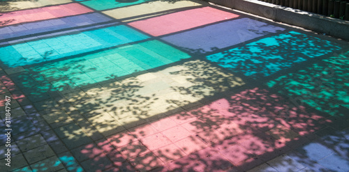 colorful canopy reflections on the street.