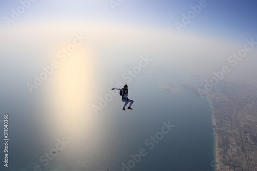 Speed. Fly men is a pilot of his body in air. Extreme people prefer skydiving. Parachutist in black suit. Free lifestyle.