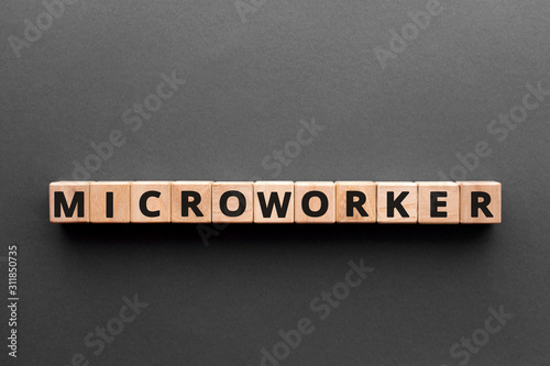 Microworker - word from wooden blocks with letters, microworkers concept, gray background